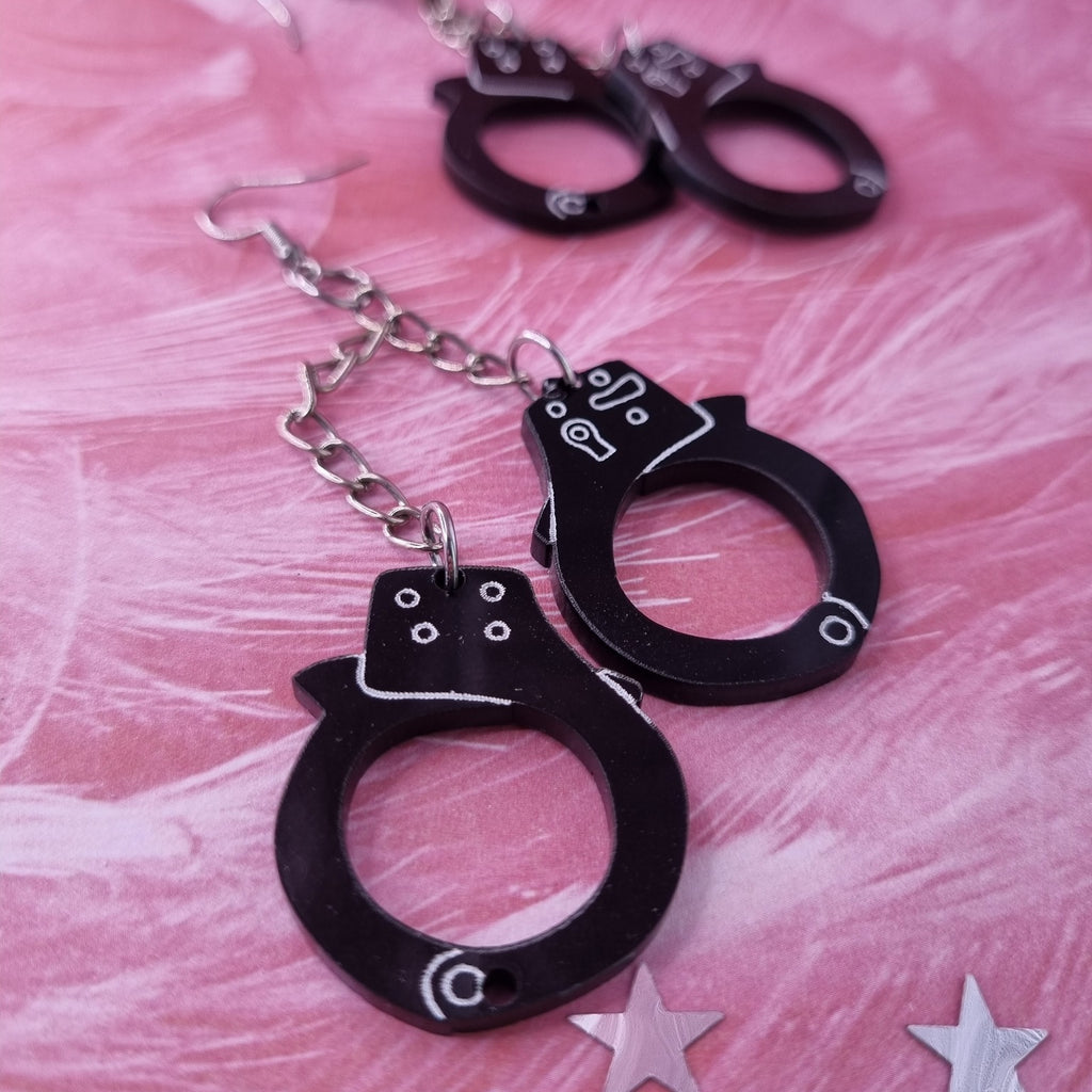 Handcuff drop earrings with two cuffs on silver-tone chain