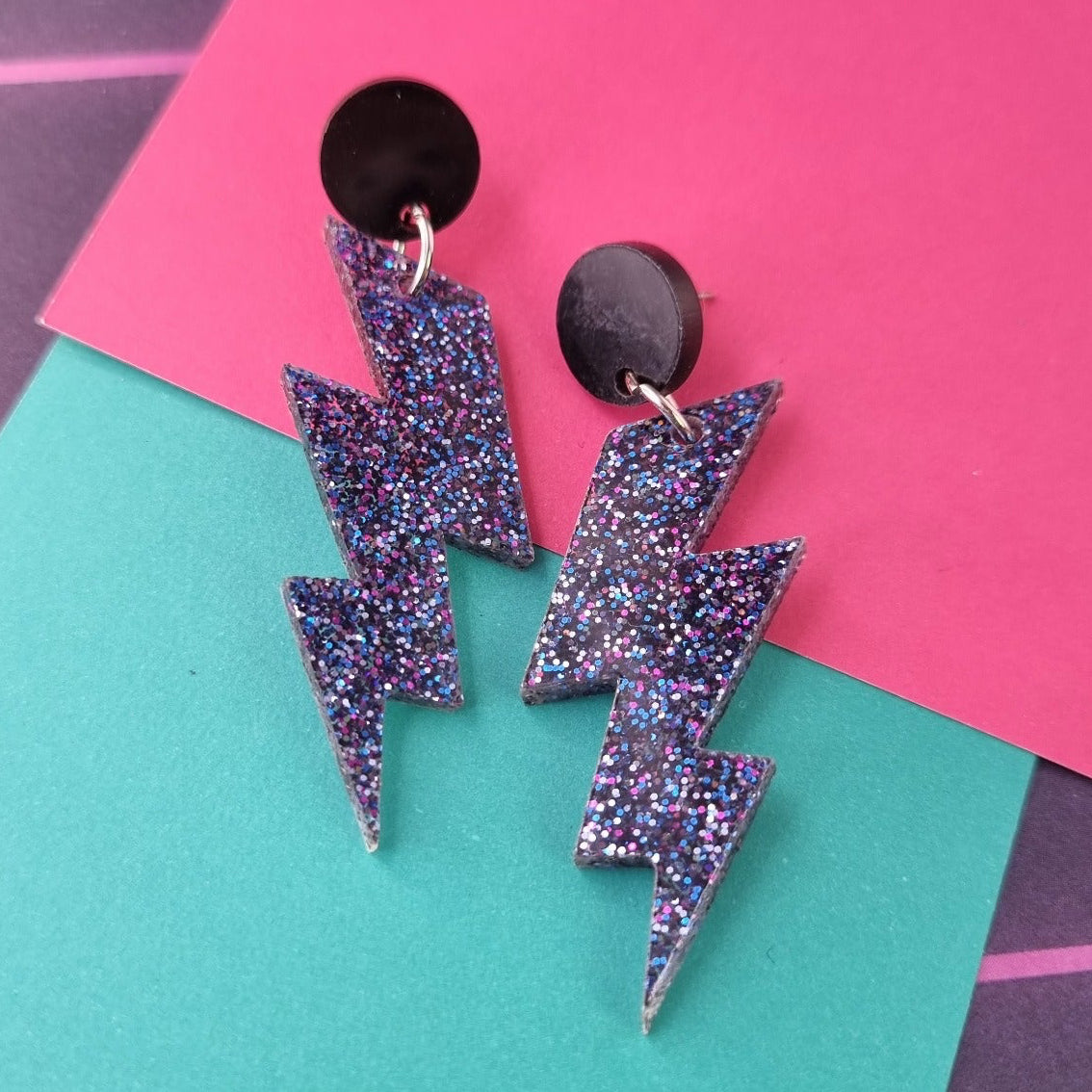 Lightning bolt drop earrings on round black studs