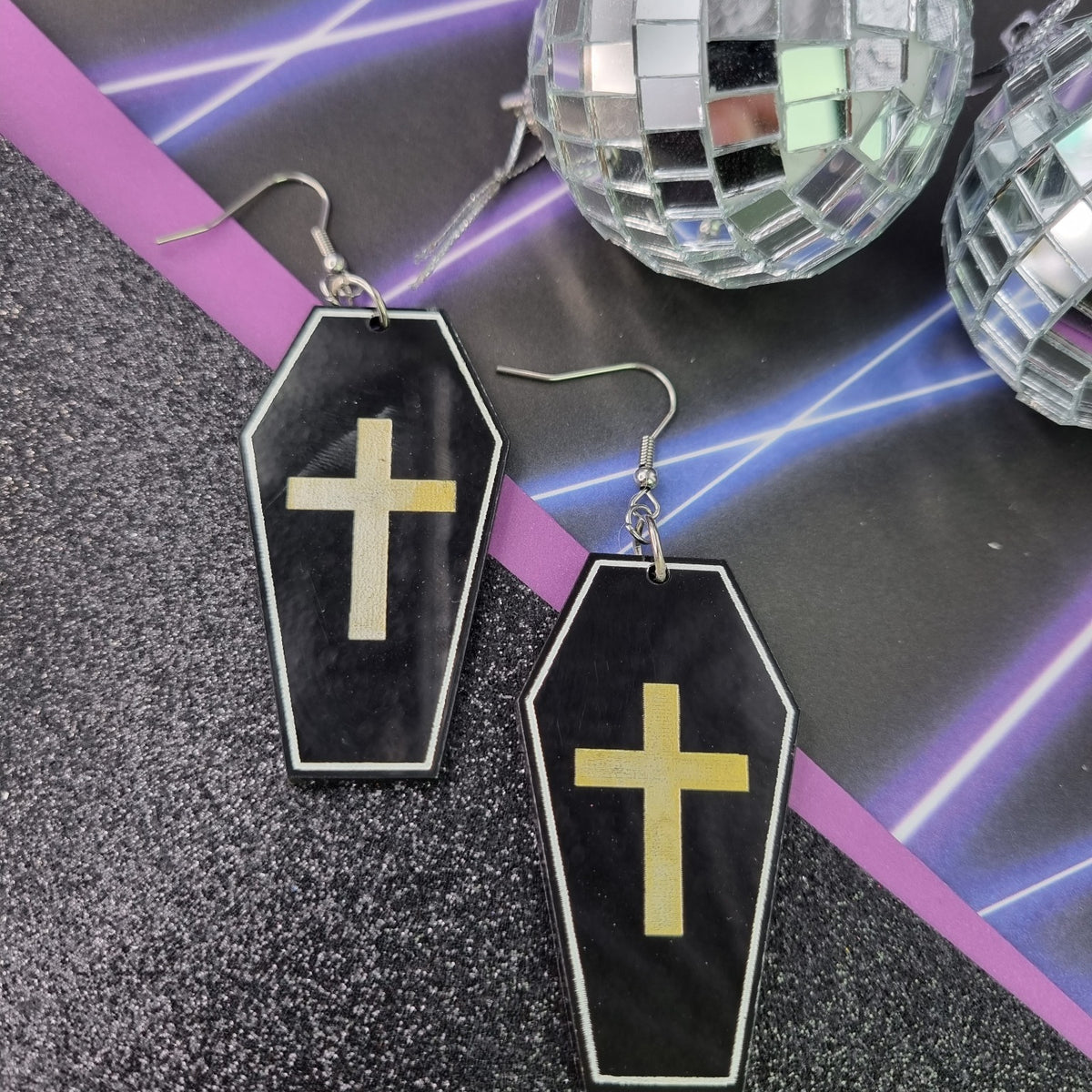 Black coffin drop earrings with white outline and gold cross, view 2