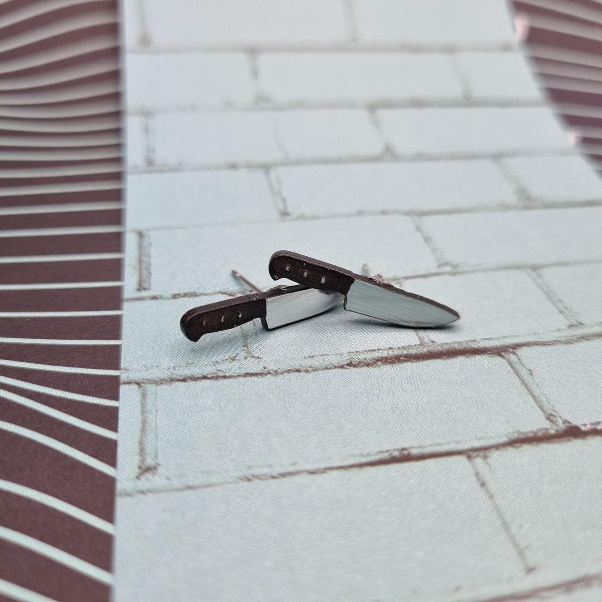 Small chef knife stud earrings with dark handles and silver blades, view 2