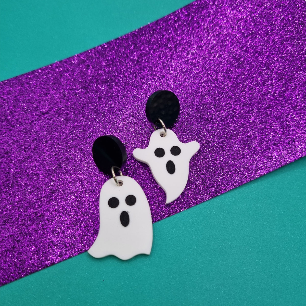 Little ghost drop earrings on round black studs