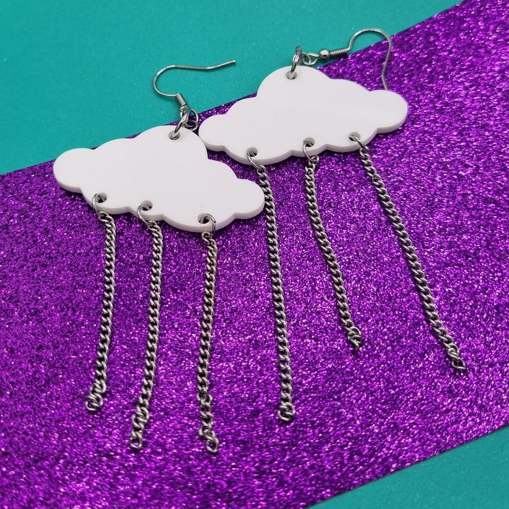 White acrylic rain cloud earrings with three hanging chain drops