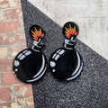 Black cartoon bomb drop earrings with flame burst stud tops