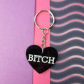 Heart keyring with white BITCH lettering