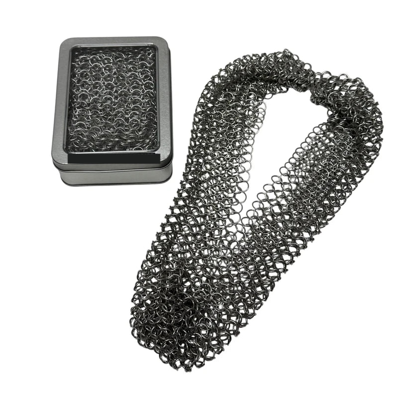 Chain maille necklace scarf beside its hinged window tin