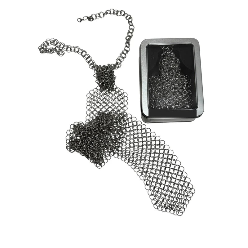 Chain maille tie coiled beside its hinged window tin