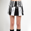 Black and white Tripp NYC x Death Note pleated skirt with shinigami print, lace-up hips and chains