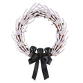 Grasping Hands Skull Wreath, grapevine wreath covered in skeleton hands with black skulls and bow