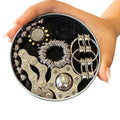 The Works Fidget Kit tin in black held in a hand